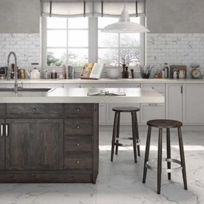 stone tile floors in a bright kitchen with wood island